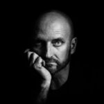 emilio barrionuevo sony alpha 7rii striking black and white portrait of a man resting his chin on his hand scaled